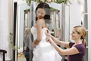 Seamstress helping bride. photo