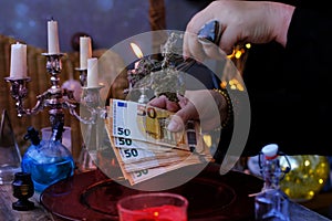 Seance in salon of soothsayer, Librate with money, female hands of psychic doing witchcraft passes with euro banknotes, esoteric