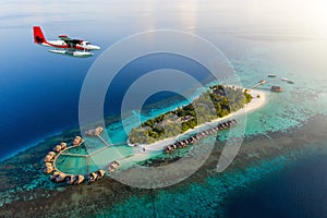 Seaplane approaching a tropical island in the Maldives photo