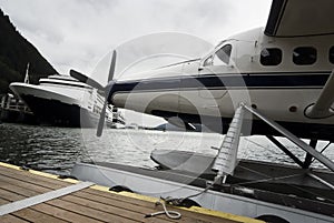 Seaplane and cruise ships docked along the pier in Alaska