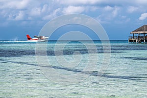 Seaplane landing in the ocean lagoon. Seaplane takeoff from the