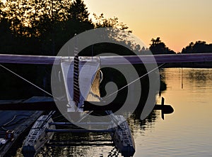 seaplane moored on the dock during sunset