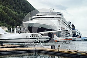 Seaplanes and cruise ships at the busy port of Juneau, Alaska