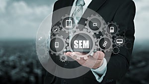 Search engine marketing - SEM concept. Businessman or programmer is focused to improve SEM and web traffic.