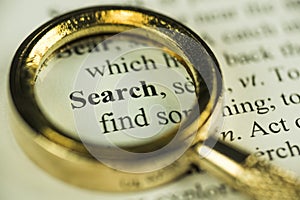 Search And Find Concept With Closeup Golden Magnifying Glass