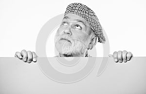 Search for inspiration. dreaming mature man in retro hat. Senior bearded man place announcement on banner. Advertisement