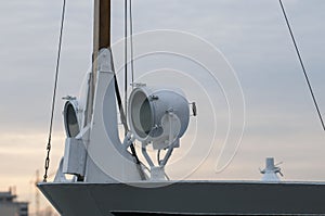 Search light attached to the side of a ship.