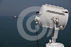 Search light and a ship in the distance
