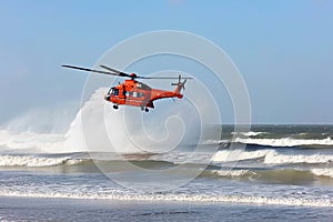 Search and rescue operation in sea. Emergency rescue helicopter flies over sea surface, looking for victims after crash