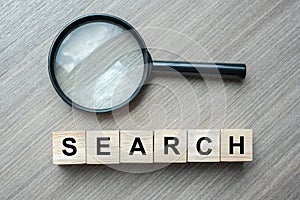 Search text wooden cubes and magnifying glass on wood table background. SEO, Idea, Vision, Strategy, Analysis, Keyword and Content