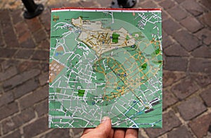 Searching for directions on a city map with hand