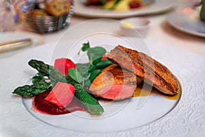 Seared duck breast, asparagus, raspberry compote a restaurant in photo