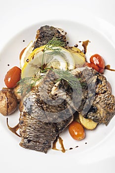 Seared fresh sea bass fillet meal with potato and vegetables