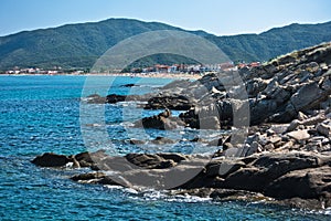 Searocks and big sandy beach of Sarti in background