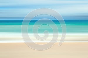 A seascape abstract with panning motion combined with a long exposure.  Image displays soft, pastel colors in a retro style