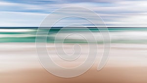 A seascape abstract with panning motion combined with a long exposure.  Image displays soft, pastel colors in a retro style