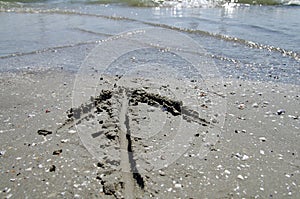 Seascape with arrow on the sandy beach. Summer, sea, sun, beach, holiday, fun - Black Sea, landmark attraction in Romania