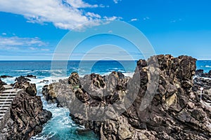 Rugged rocks of volcanic eruption that form natural sea pools in Quatro Ribeiras beach, Terceira - Azores PORTUGAL photo