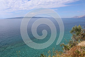 Seascape azure transparent Adriatic Sea, the island of Brac on the horizon