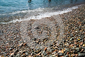 Seascape background colorful stone beach with sea wave