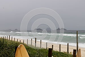 Seascape of beach mountains waves surf board