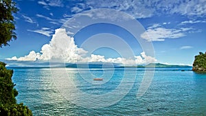 Seascape with beautiful clouds over neighboring island. Mindoro island