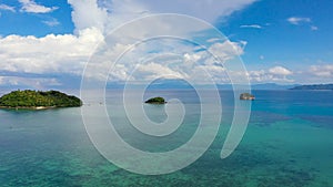 Seascape with beautiful sky and islands. Tropical islands, top view. Turquoise sea with coral reefs.