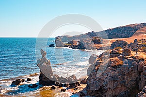 Seascape. Bizarre rocks on the seashore on a sunny summer day. General beaches of the Azov Sea