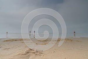 Seascape with blurred people walking in the background. Silhouette of people on the beach and in the sea. Vintage style