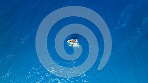 Seascape with boats. Aerial view of floating boat on blue sea at sunny day. Nautical vessel. Top view from drone on the azure sea.