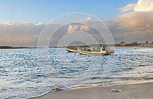 seascape with boats on Hof Dor at sunset in Israel