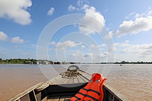 seascape with bow of wooden boat and life jacket on mekong river