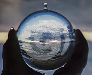 Seascape Captured in Glass Ball Held in Hand