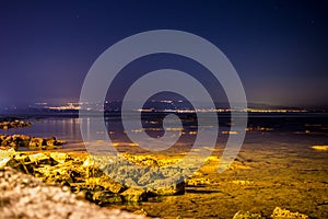 Seascape with city lights