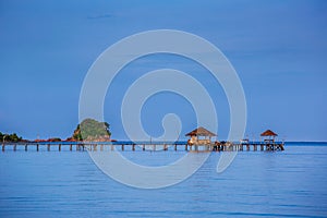 Seascape consist of blue sky, coconut palm trees, white sand beach, kayak, hammock and crystal clear emerald sea water at Koh Mak