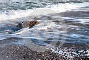 Seascape of the Crimean coast. Waves break into beautiful splashes against rocks.