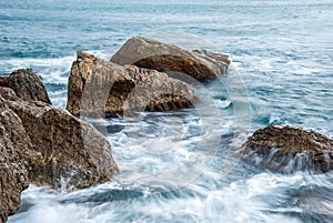 Seascape of the Crimean coast. Waves break into beautiful splashes against rocks.