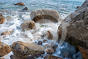 Seascape of the Crimean coast. Waves break into beautiful splashes against rocks.