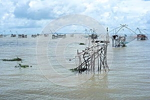 Seascape with crowd of traditional fishing tools in the sea with skyline in background