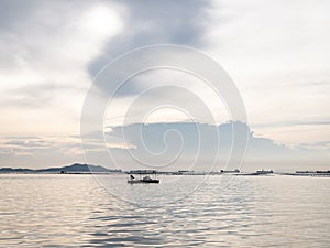 Seascape with fishing boat and mussel farm in sunset. panorama sea view at dawn. copy space.