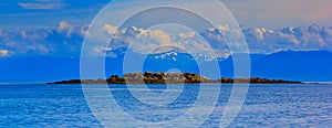 A seascape of Frederick sound, Alaska with small rocky island an photo