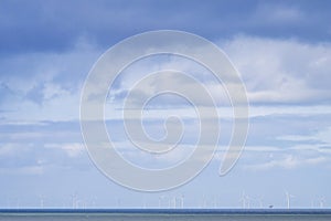 Seascape and horizon in front the Rotterdam harbor with wind turbines