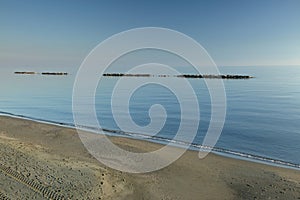 Seascape with horizon in the sea, piece of sandy beach, calmness, paradise