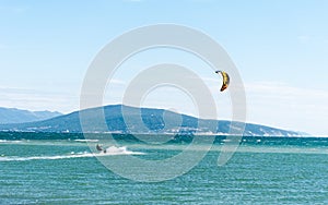 Seascape with a kite. kite on the sea waves. a man rides a kite. sports and adrenaline