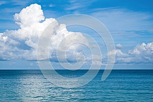 Seascape with a large white cloud on a blue sky