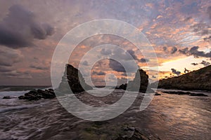 Seascape and magnificent dramatic sunrise over Rock formation The Ships