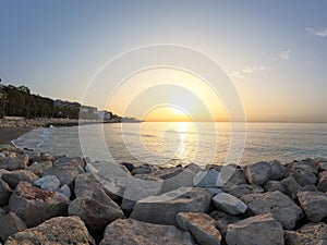 Seascape with Malaga and sunrise sunlight. Sandy beach of the Mediterranean Sea and walking stone pier in Playa de la Caleta, photo