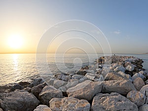 Seascape with Malaga and sunrise sunlight. Sandy beach of the Mediterranean Sea and walking stone pier in Playa de la Caleta, photo