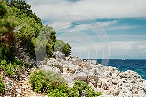 Seascape, Mediterranean coast. White rocks stones and blue water, sky with clouds