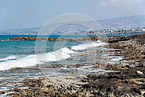 Seascape of the Mediterranean Sea with waves of the turquoise sea on the volcanic coast of Cyprus